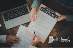 Two people signing a real estate purchase contract in Indiana