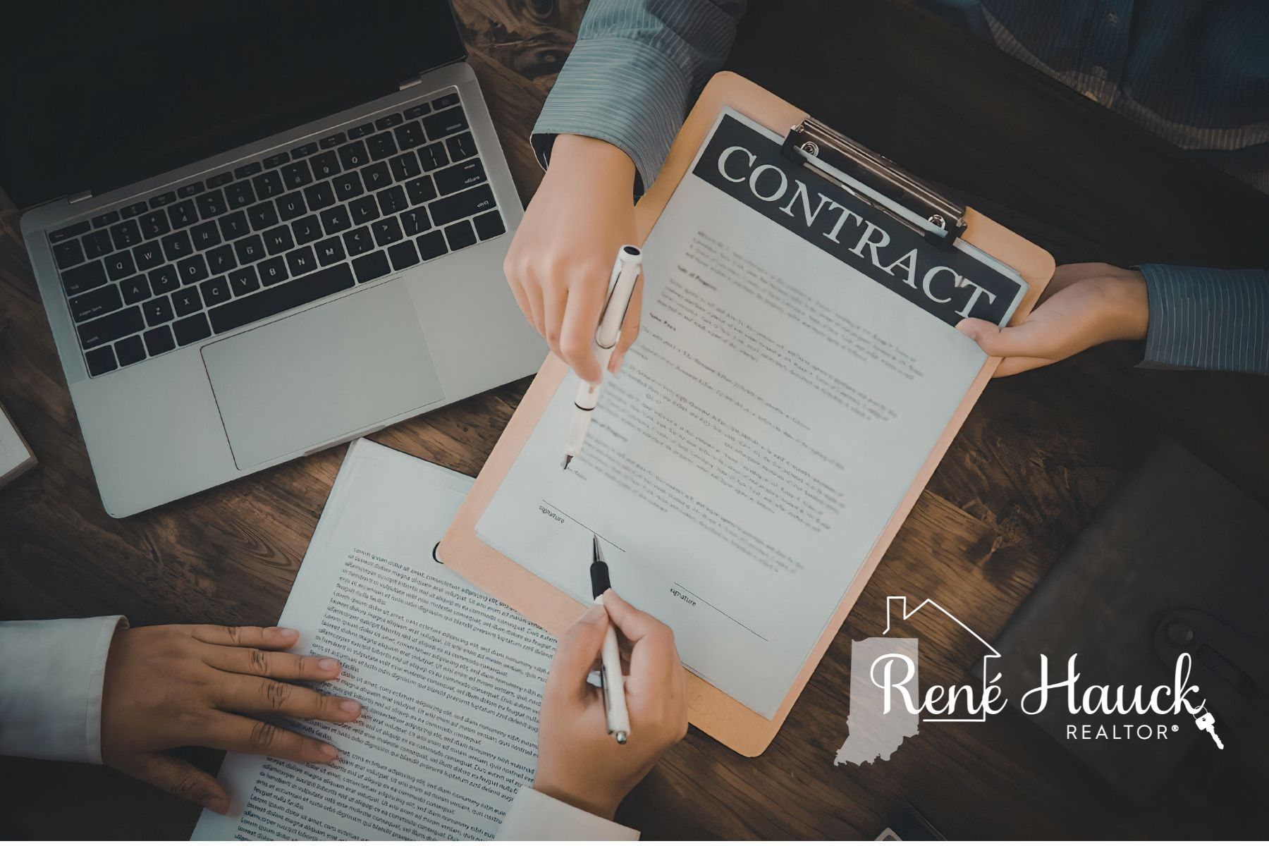 Two people signing a real estate purchase contract in Indiana
