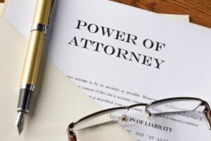 Power of attorney document with fountain pen and glasses — Indiana home sale legal authority