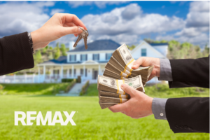 Hands exchanging stacks of cash for house keys in front of a home, showing a cash offer on an Indiana home sale.